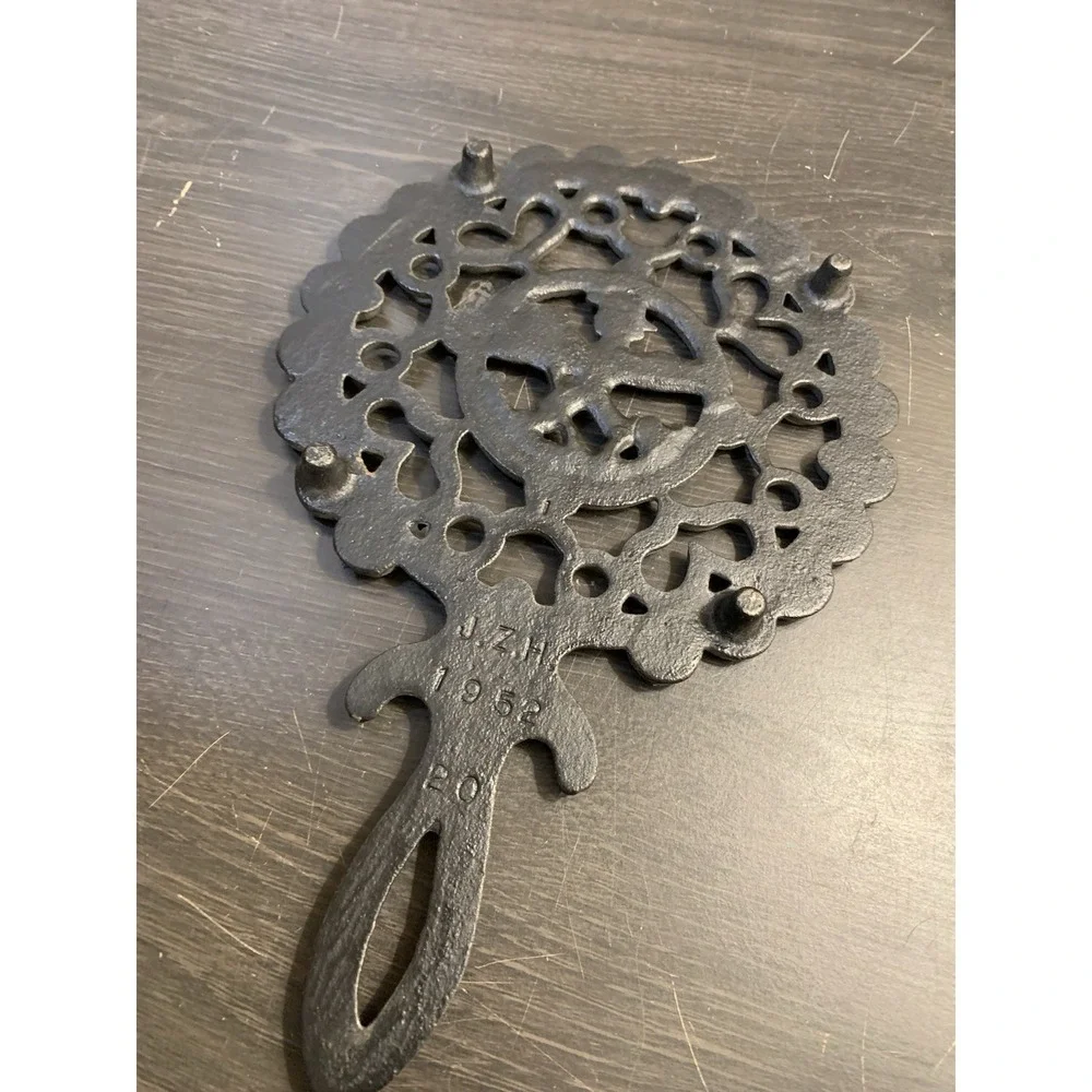 Two Fancy Vintage Cast Iron Trivets Black J.Z.H Amish Boy Girl 1952